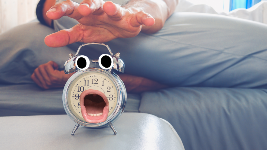 Man turning off shocked alarm clock