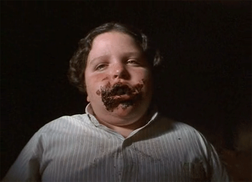 Someone enjoying a small piece of chocolate